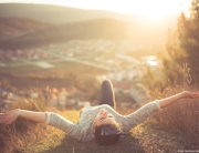 woman lying on the ground while on vacation