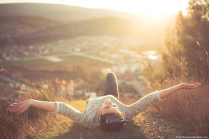woman lying on the ground while on vacation